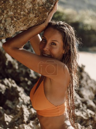 Photo for Beautiful woman in yellow bikini at tropical beach. - Royalty Free Image