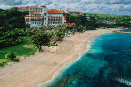 Tropical beach with luxury hotel resort and ocean in Bali island. Aerial view