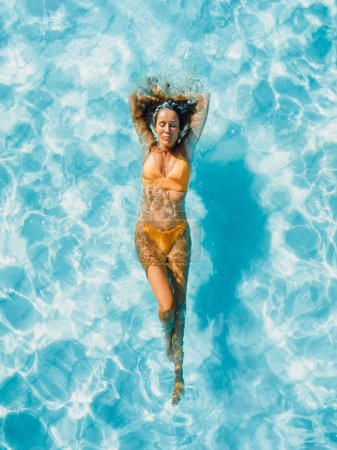 Foto de Mujer sexy flotando en el océano azul transparente en Bahamas. Vista aérea, vista superior. - Imagen libre de derechos