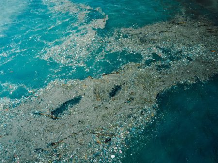 Photo for Ocean water and plastic trash in Bali island. Aerial view of pollution by plastic rubbish - Royalty Free Image