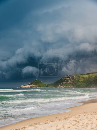 Photo for Scenic beach with sunlight before an oncoming storm. Mole beach in Florianopolis - Royalty Free Image