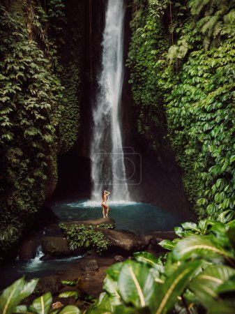 Photo for Scenic Leke leke waterfall and woman in bikini near waterfall. - Royalty Free Image