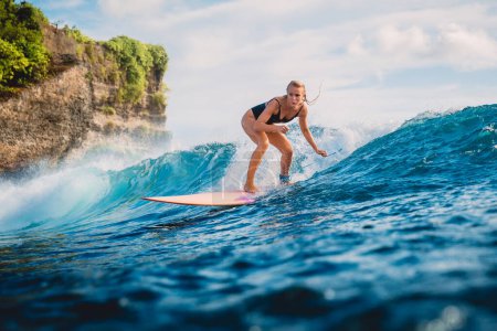 Photo for Surf girl on surfboard. Woman in ocean during surfing. Surfer on longboard and ocean wave - Royalty Free Image