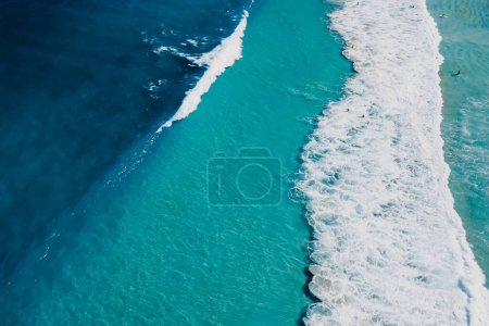 Photo for Top view of blue transparent ocean with crashing waves, aerial view - Royalty Free Image