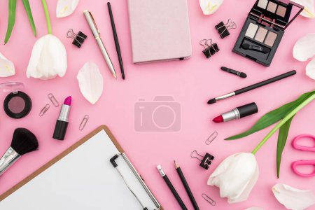Photo for Beauty female blogger composition with clipboard, flowers, cosmetics and accessory isolated on pink background. Top view. Flat lay. - Royalty Free Image
