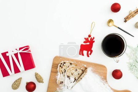 Photo for Christmas composition with stollen cake and coffee cup, tree toys and gift box on white. Flat lay, top view. Cpoy space - Royalty Free Image