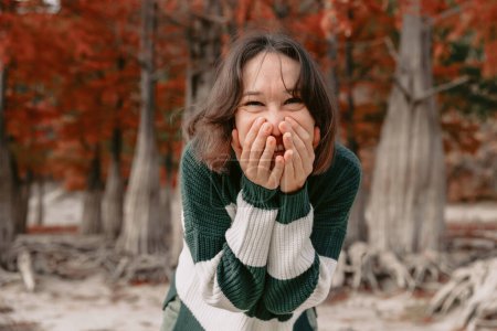 Photo for Lifestyle portrait of smiling woman in autumnal park. Stylish woman with happy emotions - Royalty Free Image