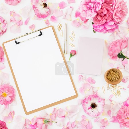Photo for Floral frame of pink roses flowers with clipboard on white background. Flat lay, Top view. - Royalty Free Image