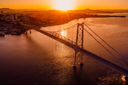 Téléchargez les photos : Pont Hercilio luz avec coucher de soleil chaud à Florianopolis, Brésil. Vue aérienne - en image libre de droit