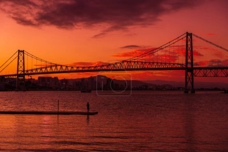 Photo for Hercilio luz cable bridge and bright warm sunset in Florianopolis - Royalty Free Image