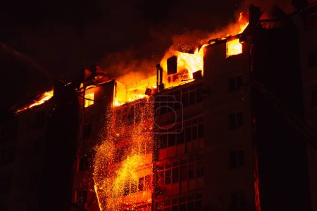 Photo for Pieces of the house fall due to the fire. Fire blazing building. - Royalty Free Image