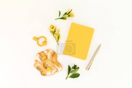 Photo for Resin art with yellow diary, pen and leaves on white background. Flat lay, top view - Royalty Free Image