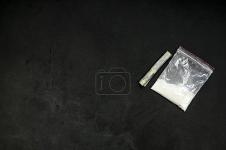 Photo for Cocaine powder lines, rolled banknote and drugs in plastic bag pocket on black glass surface background, top view. Drug addiction concept dark - Royalty Free Image