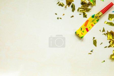 Photo for Birthday party blowouts whistles Rolled festive noisemaker or party whistle on concrete light background, blowing in whistle top view in and out loop 4k Happy Birthday copy space - Royalty Free Image