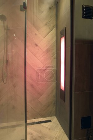 Sunshower in a bathroom,with uv lights, lights glowing while water is flowing. worked Solarium with ultraviolet light. Infra red lights body relexation luxury