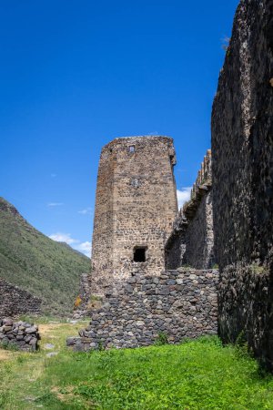 Photo for Khertvisi Fortress lower courtyard in Georgia, stone medieval castle wall with watchtowers and citadel on a green rocky hill in Lesser Caucasus mountains in Samtskhe - Javakheti (Meskheti) region. - Royalty Free Image
