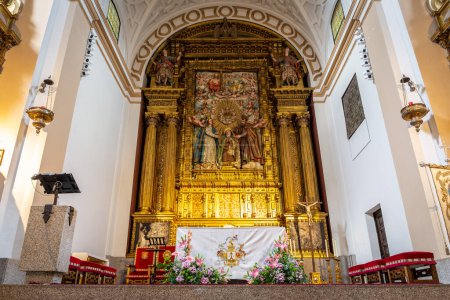 Photo for Avila, Spain, 07.10.21. Baroque gold decorated altar with Saint Teresa of Jesus statue in the Convent of Santa Teresa, inside view. - Royalty Free Image