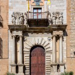 Toledo, Spain, 08.10.21. Archbishop's Palace of Toledo (Palacio Arzobispal de Toledo) main portal and facade with columns, tympanum, sculptures and coat of arms, Spain.