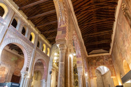 Photo for Toledo, Spain, 08.10.21. Church of San Roman (Museum of the Councils and Visigoth Culture) inside view with Romanesque colorful frescos, Mudejar decorations and arches. - Royalty Free Image
