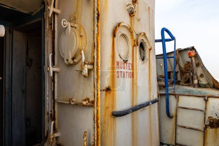 Muster station (ship assembly point), entrance to wheelhouse with watertight hatches on demolished cargo ship wreck on the Al Hamriyah beach in Umm Al Quwain, United Arab Emirates.