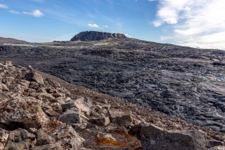 Fagradalsfjall volcano lava field landscape with frozen basaltic lava created after eruption, steaming vents and new crater cone, Iceland.