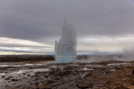 Strokkur geyser erupting, fountain-type geyser in geothermal area in Iceland, no people.