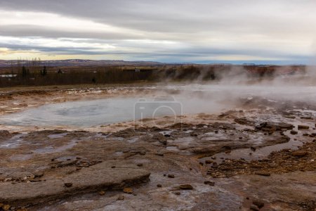 Strokkur geyser pool before erupting, steaming volcanic hot springs in Geysir geothermal area in Haukadular valley, Iceland.