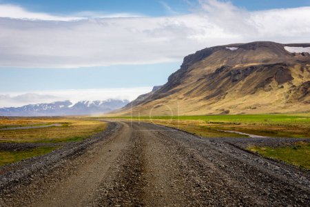 Mountain landscape of the Thorsmork valley in South Iceland with gravel road F249 and green vegetation.