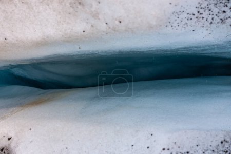 Deep, blue crevasse in glacier ice in Skaftafell Glacier, part of Vatnajokull National Park, Iceland, top view.