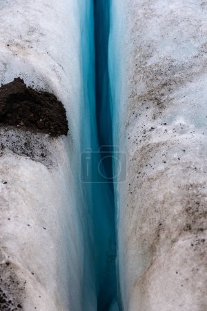 Deep, blue crevasse in glacier ice in Skaftafell Glacier, part of Vatnajokull National Park, Iceland, top view.