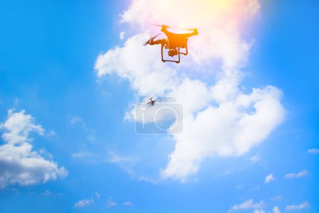 Photo for Drone copter flying silhouette against the sunset sky background. - Royalty Free Image