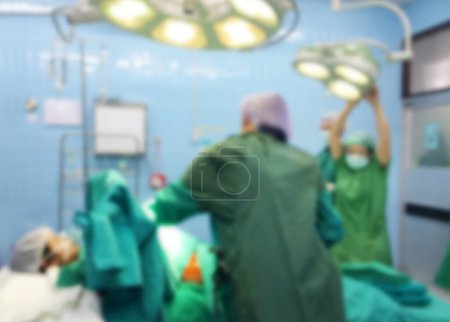 Foto de Motion blur with Medical team performing surgery on a girl cesarean in hospital. Medical team in operating room. - Imagen libre de derechos