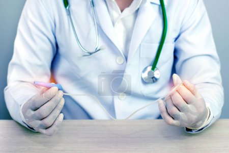 Photo for Hands and remedial catheter. Hygienic care of the patient.(blue tone concept) - Royalty Free Image