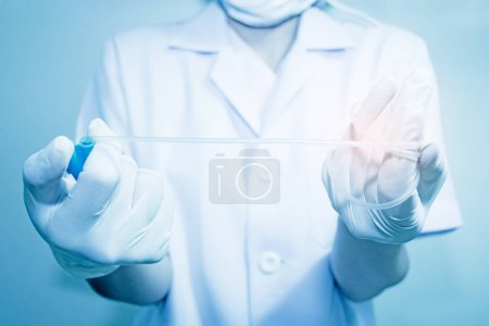 Photo for Hands and remedial catheter. Hygienic care of the patient.(blue tone concept - Royalty Free Image