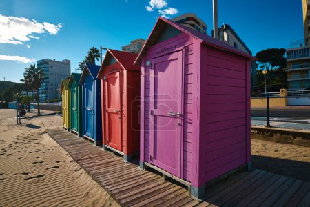 Brightly painted summer beach change rooms at the beach