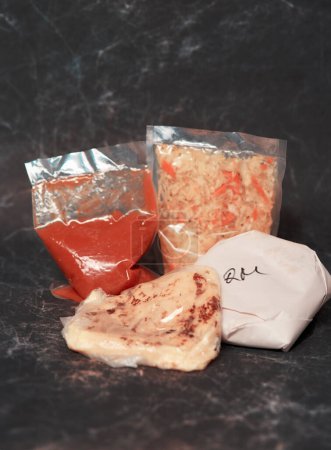 ake-away pupusas wrapped in paper and plastic, served with curtido and sauce, ready to enjoy anywhere.