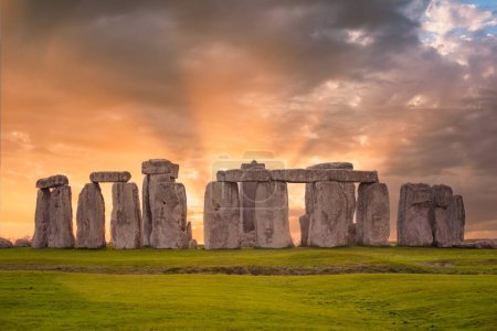 Téléchargez les photos : Coucher de soleil incroyable à Stonehenge en Angleterre avec un ciel et des rayons de soleil spectaculaires - en image libre de droit