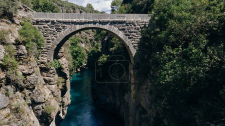 Photo for Ancient arch bridge over the Koprucay river gorge in Koprulu national Park in Turkey. . High quality photo - Royalty Free Image