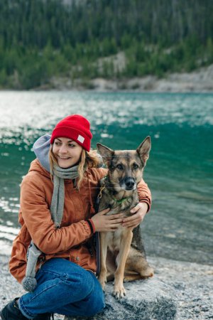 Human and a dog. female and her friend dog husky on the nature forests and rivers background. . High quality photo