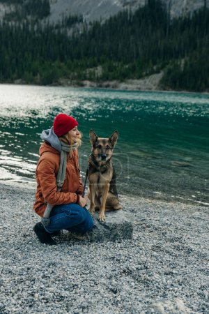 Human and a dog. female and her friend dog husky on the nature forests and rivers background. . High quality photo