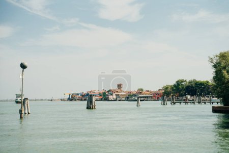 View of the San Michele Arcangelo bell tower and the colorful houses of Mazzorbo, Venice - sep, 2021. High quality photo