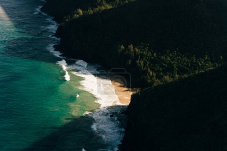 Hawaii Kauai Na Pali coast landscape aerial view from helicopter. Nature coastline dramatic mountains with secluded popular tourist attraction beach. USA destination. High quality photo