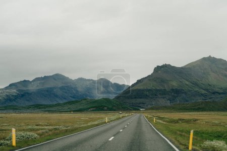 road through green mountains in iceland. High quality photo