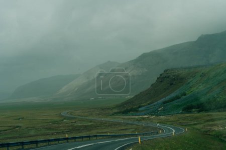 road through green mountains in iceland. High quality photo
