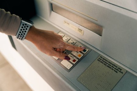 girl presses the buttons at the ATM. High quality photo