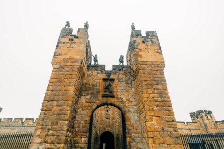 Photo for Alnwick Castle. The walls of an ancient castle in the north of England. The old castle and its gate . High quality photo - Royalty Free Image
