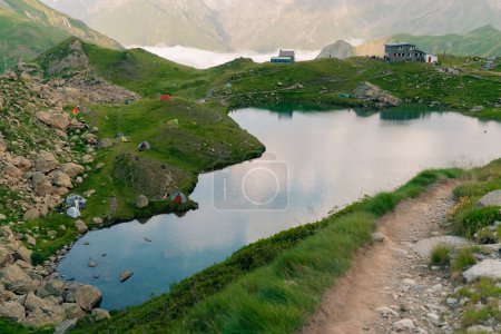 Pombie refuge with people under the Midi d'Ossau. Pyrenees National Park. High quality photo