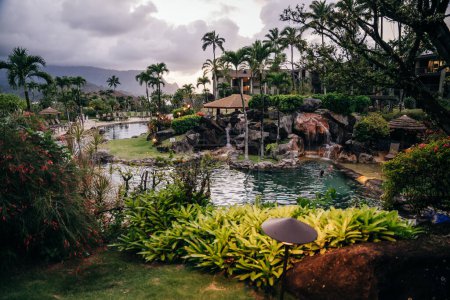 Princeville, Kauai, HI - April 24, 2023 - The Westin Resort pool and cabana at sunset in Princeville. High quality photo