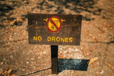 No drones all remote controlled aircraft are prohibited sign. wooden plaque in the national park. High quality photo