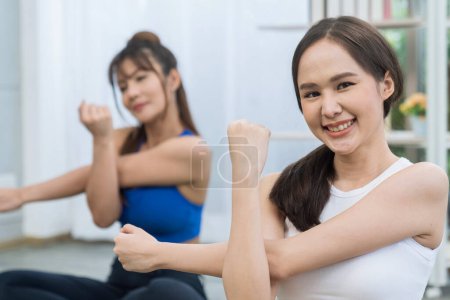 Photo for Couple woman yoga. Sport woman. Two women exercising stretching at the living room. - Royalty Free Image